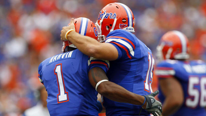 October 25, 2008; Gainesville FL, USA; Florida Gators quarterback Tim Tebow (15) hugs Florida Gators receiver Percy Harvin (1) after he scored a touchdown during the first half against the Kentucky Wildcats at Ben Hill Griffin Stadium. Mandatory Credit: Kim Klement-Imagn Images