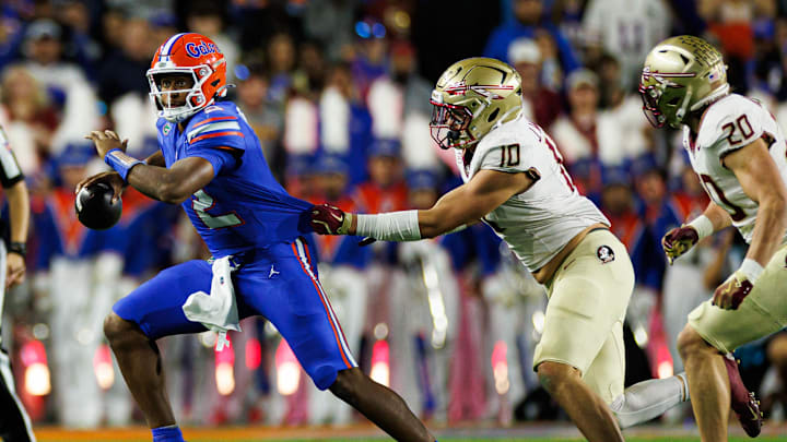 Nov 29, 2025; Gainesville, Florida, USA; Florida Gators quarterback DJ Lagway (2) runs with the ball while Florida State Seminoles defensive lineman James Williams (10) grabs his jersey during the first half at Ben Hill Griffin Stadium. Mandatory Credit: Matt Pendleton-Imagn Images Nov 29, 2025; Gainesville, Florida, USA; Florida Gators quarterback DJ Lagway (2) runs with the ball while Florida State Seminoles defensive lineman James Williams (10) grabs his jersey during the first half at Ben Hill Griffin Stadium. Mandatory Credit: Matt Pendleton-Imagn Images