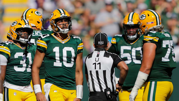 Green Bay Packers quarterback Jordan Love (10) grabs his leg after running the ball against the Minnesota Vikings during their football game Sunday, September 29, 2024, at Lambeau Field in Green Bay, Wisconsin.