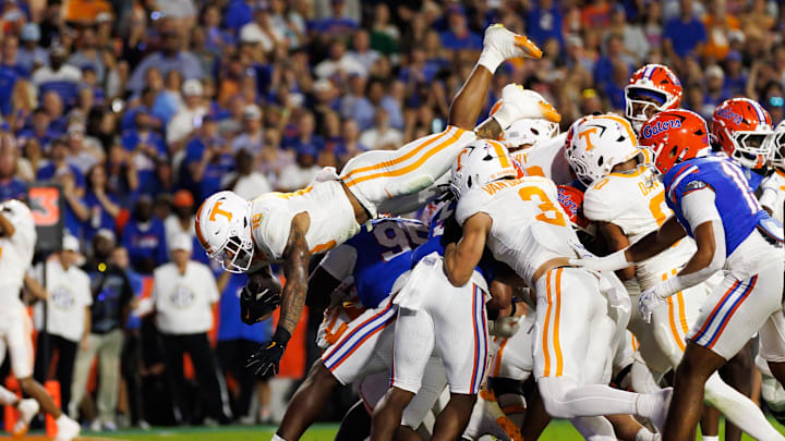 Nov 22, 2025; Gainesville, Florida, USA; Tennessee Volunteers running back Desean Bishop (18) leaps over the defense for a touchdown against the Florida Gators during the first half at Ben Hill Griffin Stadium. Mandatory Credit: Matt Pendleton-Imagn Images