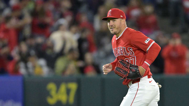 Apr 6, 2024; Anaheim, California, USA; Los Angeles Angels outfielder Mike Trout (27) jogs to the dugout after making a leaping catch at the wall off a fly ball hit by Boston Red Sox outfielder Jarren Duran (16) in the eighth inning at Angel Stadium. Mandatory Credit: Jayne Kamin-Oncea-Imagn Images Apr 6, 2024; Anaheim, California, USA; Los Angeles Angels outfielder Mike Trout (27) jogs to the dugout after making a leaping catch at the wall off a fly ball hit by Boston Red Sox outfielder Jarren Duran (16) in the eighth inning at Angel Stadium. Mandatory Credit: Jayne Kamin-Oncea-Imagn Images