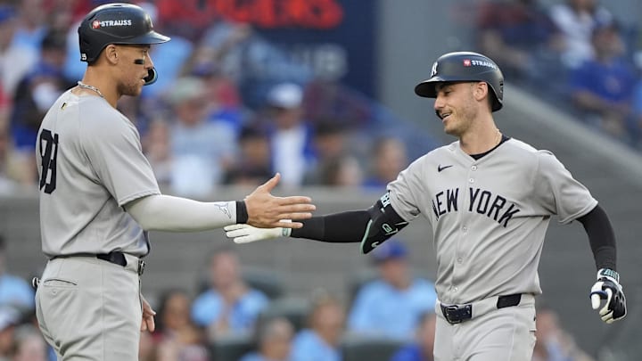 Oct 5, 2025; Toronto, Ontario, CAN; New York Yankees right fielder Aaron Judge (99) congratulates left fielder Cody Bellinger (35) after a two-run home run in the sixth inning against the Toronto Blue Jays during game two of the ALDS round for the 2025 MLB playoffs at Rogers Centre. Mandatory Credit: John E. Sokolowski-Imagn Images