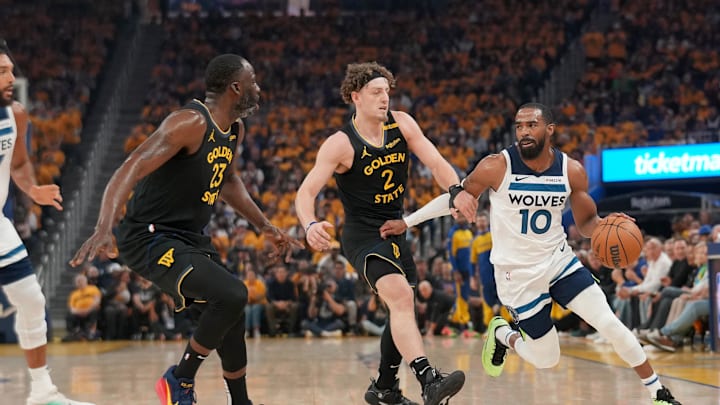 May 12, 2025; San Francisco, California, USA; Minnesota Timberwolves guard Mike Conley (10) dribbles the ball next to Golden State Warriors guard Brandin Podziemski (2) and forward Draymond Green (23) in the first quarter during game four of the second round for the 2025 NBA Playoffs at Chase Center. Mandatory Credit: Cary Edmondson-Imagn Images