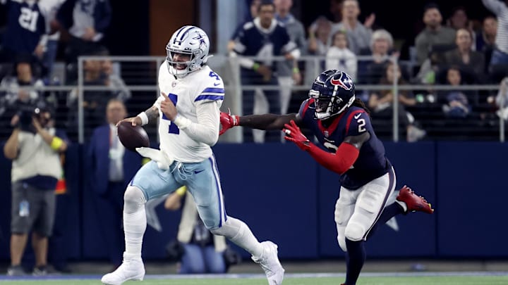 Dec 11, 2022; Arlington, Texas, USA;  Dallas Cowboys quarterback Dak Prescott (4) runs away from