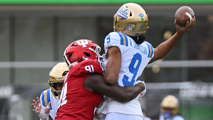Oct 25, 2025; Bloomington, Indiana, USA; Indiana Hoosiers defensive lineman Dominique Ratcliff (91) hits UCLA Bruins quarterback Nico Iamaleava (9) as he throws a pass during the second half at Memorial Stadium. Mandatory Credit: Robert Goddin-Imagn Images