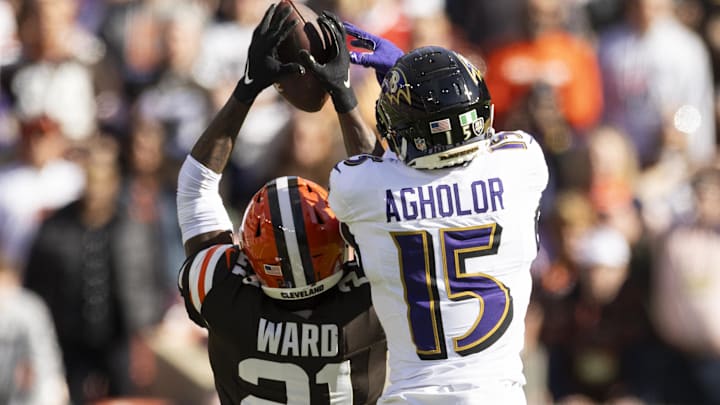 Oct 27, 2024; Cleveland, Ohio, USA; Cleveland Browns cornerback Denzel Ward (21) breaks up a pass intended for Baltimore Ravens wide receiver Nelson Agholor (15) during the second quarter at Huntington Bank Field. Mandatory Credit: Scott Galvin-Imagn Images
