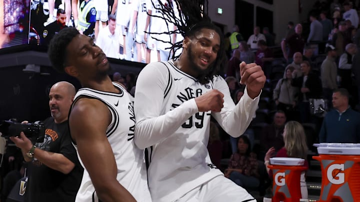 Feb 14, 2026; Nashville, Tennessee, USA;  Vanderbilt Commodores forward Ak Okereke (10) and forward Devin McGlockton (99) celebrates the win against the Texas A&M Aggies during the second half at Memorial Gymnasium. Mandatory Credit: Steve Roberts-Imagn Images