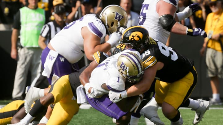Iowa’s Aaron Graves (95) tackles Washington Washington running back Jonah Coleman (1) Saturday, Oct. 12, 2024 at Kinnick Stadium in Iowa City, Iowa.