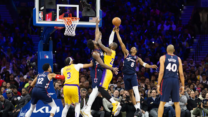 Nov 27, 2023; Philadelphia, Pennsylvania, USA; Philadelphia 76ers center Joel Embiid (21) and guard De'Anthony Melton (8) defend the drive attempt of Los Angeles Lakers forward LeBron James (23) during the third quarter at Wells Fargo Center. Mandatory Credit: Bill Streicher-Imagn Images