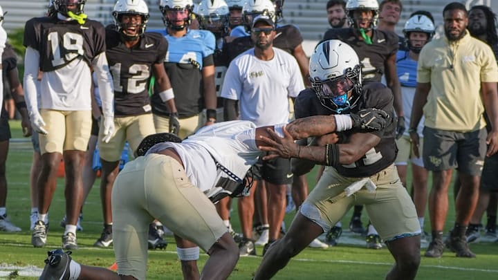 UCF running back Stacy Gage competes with Qua Birdsong during UCF Spring football practice at FBC Mortgage Stadium in Orlando, Friday, April 11, 2025.