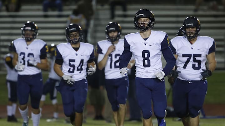 Flowing Wells' Lloyd Love (8) and his teammates take the field to play Millennium during the first round of the AIA State Football Playoffs at Millennium High School in Goodyear, Ariz. on Nov. 2, 2018.

Z6i2633