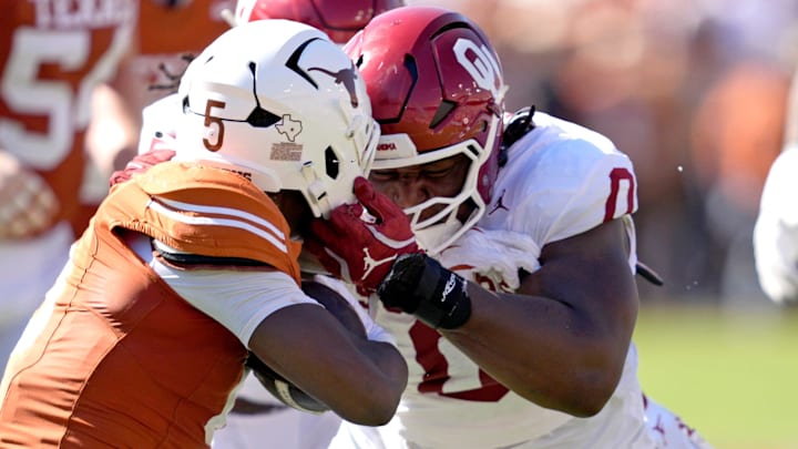 Oklahoma Sooners defensive lineman David Stone (0) tackles Texas Longhorns running back Quintrevion Wisner (5) in the first half of the Red River Rivalry, Oct. 11, 2025 at the Cotton Bowl Stadium in Dallas, Texas.