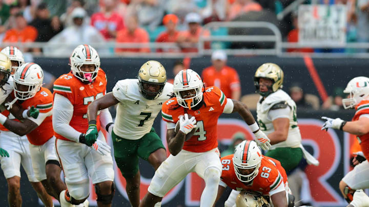Sep 13, 2025; Miami Gardens, Florida, USA; Miami Hurricanes running back Mark Fletcher Jr. (4) runs with the football against the South Florida Bulls during the first quarter at Hard Rock Stadium. Mandatory Credit: Sam Navarro-Imagn Images
