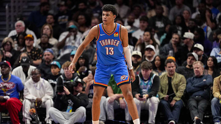 Nov 15, 2025; Charlotte, North Carolina, USA; Oklahoma City Thunder forward Ousmane Dieng (13) on defense against the Charlotte Hornets during the second half at Spectrum Center. Mandatory Credit: Jim Dedmon-Imagn Images