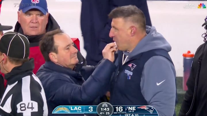 Mike Vrabel receives medical attention after getting a bloody lip from a player. Mike Vrabel receives medical attention after getting a bloody lip from a player.