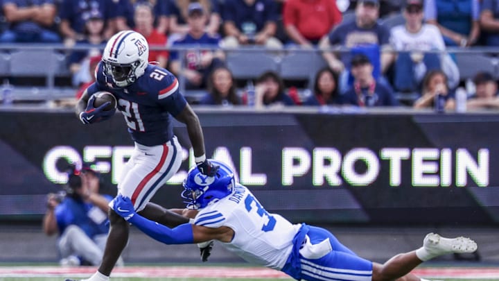 Oct 11, 2025; Tucson, Arizona, USA; Brigham Young Cougars safety Raider Damuni (3) tackles Arizona Wildcats running back Ismail Mahdi (21) during the first quarter of the game at Arizona Stadium. Mandatory Credit: Aryanna Frank-Imagn Images