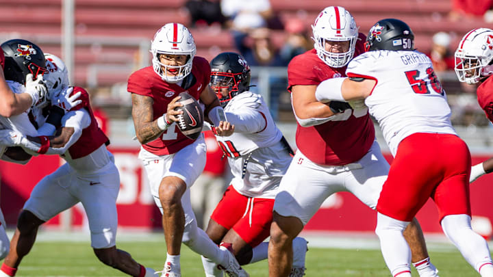 Nov 16, 2024; Stanford, California, USA;  Stanford Cardinal quarterback Ashton Daniels (14) is chased down from behind during the first quarter against the Louisville Cardinals at Stanford Stadium. Mandatory Credit: Bob Kupbens-Imagn Images