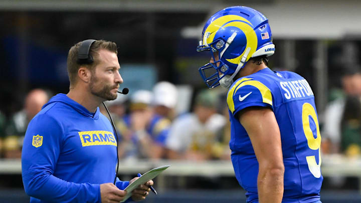 Oct 6, 2024; Inglewood, California, USA; Los Angeles Rams head coach Sean McVay talks to quarterback Matthew Stafford (9) during the third quarter against the Green Bay Packers at SoFi Stadium. Mandatory Credit: Robert Hanashiro-Imagn Images