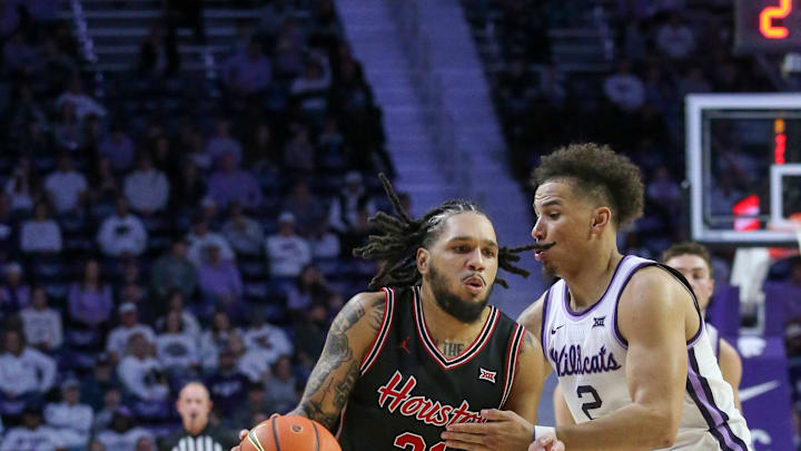 Jan 11, 2025; Manhattan, Kansas, USA; Houston Cougars guard Emanuel Sharp (21) dribbles against Kansas State Wildcats guard Max Jones (2) during the second half at Bramlage Coliseum. Mandatory Credit: Scott Sewell-Imagn Images