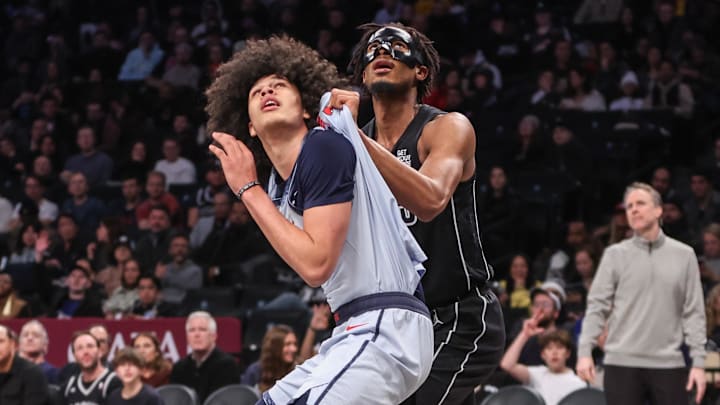 Feb 5, 2025; Brooklyn, New York, USA;  Washington Wizards forward Kyshawn George (18) and Brooklyn Nets center Nic Claxton (33) box out for a rebound in the third quarter at Barclays Center. Mandatory Credit: Wendell Cruz-Imagn Images