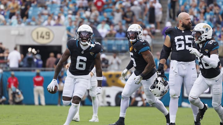 Nov 10, 2024; Jacksonville, Florida, USA; Jacksonville Jaguars safety Darnell Savage (6) celebrates an interception with safety Antonio Johnson (26) against the Minnesota Vikings during the third quarter at EverBank Stadium. Mandatory Credit: Morgan Tencza-Imagn Images