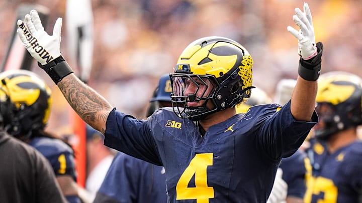 Michigan edge TJ Guy (4) celebrates a play against Washington during the second half at Michigan Stadium in Ann Arbor on Saturday, Oct. 18, 2025.