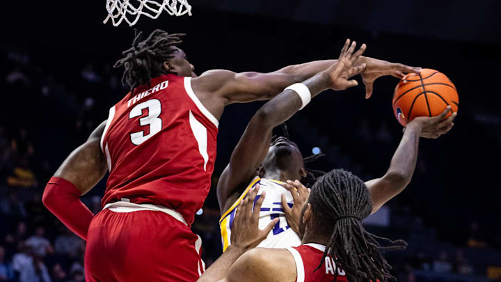 Jan 14, 2025; Baton Rouge, Louisiana, USA;  LSU Tigers guard Jordan Sears (1) has a shot blocked by Arkansas Razorbacks forward Adou Thiero (3) during the first half at Pete Maravich Assembly Center. Mandatory Credit: Stephen Lew-Imagn Images