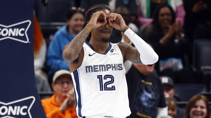 Memphis Grizzlies guard Ja Morant (12) reacts after a dunk during the first half against the Miami Heat at FedExForum. 