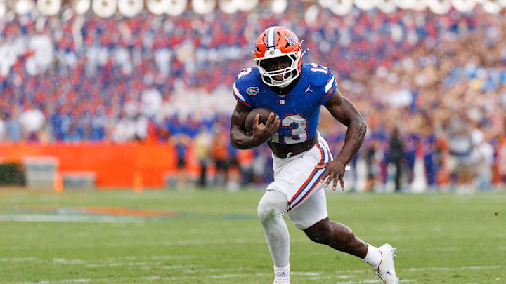 Oct 4, 2025; Gainesville, Florida, USA; Florida Gators running back Jadan Baugh (13) rushes with the ball against the Texas Longhorns during the first half at Ben Hill Griffin Stadium. Mandatory Credit: Matt Pendleton-Imagn Images