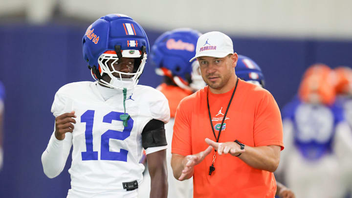 Florida head coach Jon Sumrall talks with Florida cornerback Ben Hanks II (12) during practice during spring practice at Sanders Practice Fields in Gainesville, FL on Thursday, April 2, 2026. [Alan Youngblood/Gainesville Sun]