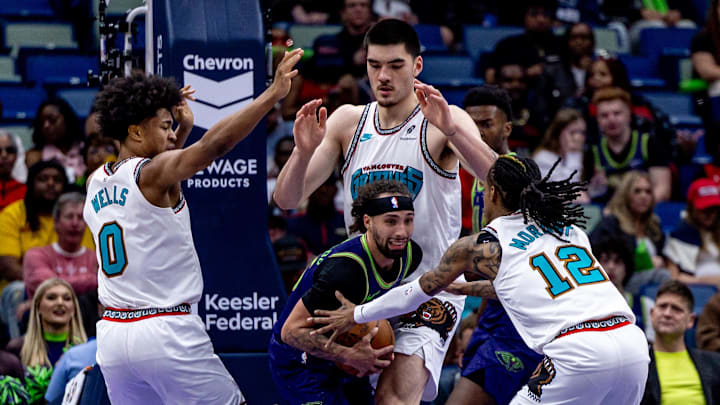 Mar 9, 2025; New Orleans, Louisiana, USA;  New Orleans Pelicans guard Jose Alvarado (15) fights for position against Memphis Grizzlies guard Ja Morant (12) and forward Jaylen Wells (0) and center Zach Edey (14) during the second half at Smoothie King Center. Mandatory Credit: Stephen Lew-Imagn Images