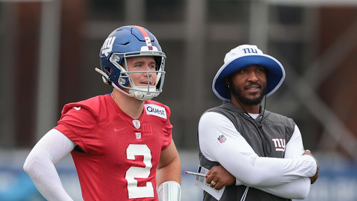 Jul 24, 2024; East Rutherford, NJ, USA; New York Giants quarterback Drew Lock (2) and assistant quarterback coach Christian Jones look on during training camp at Quest Diagnostics Training Facility.  