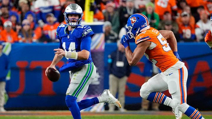 Oct 15, 2026; Denver, Colorado, USA; Seattle Seahawks quarterback Sam Darnold (14) looks to throw while pressured by Denver Broncos linebacker Jonah Elliss (52) in the second quarter at Empower Field at Mile High. Mandatory Credit: Ron Chenoy-Imagn Images Oct 15, 2026; Denver, Colorado, USA; Seattle Seahawks quarterback Sam Darnold (14) looks to throw while pressured by Denver Broncos linebacker Jonah Elliss (52) in the second quarter at Empower Field at Mile High. Mandatory Credit: Ron Chenoy-Imagn Images