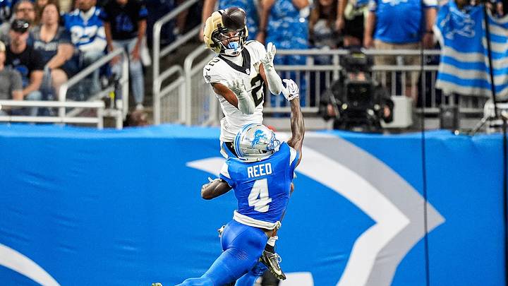 New Orleans Saints wide receiver Chris Olave (12) makes a catch against Detroit Lions cornerback D.J. Reed (4) during the second half at Ford Field in Detroit on Sunday, Sept. 13, 2026. New Orleans Saints wide receiver Chris Olave (12) makes a catch against Detroit Lions cornerback D.J. Reed (4) during the second half at Ford Field in Detroit on Sunday, Sept. 13, 2026.