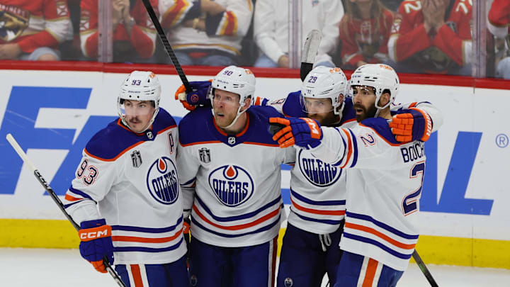 Jun 18, 2024; Sunrise, Florida, USA; Edmonton Oilers forward Corey Perry (90) celebrates scoring against Florida Panthers with forward Ryan Nugent-Hopkins (93) and forward Leon Draisaitl (29) and defenseman Evan Bouchard (2) during the second period in game five of the 2024 Stanley Cup Final at Amerant Bank Arena. Mandatory Credit: Sam Navarro-Imagn Images