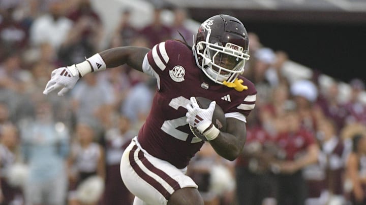 Nov 2, 2024; Starkville, Mississippi, USA; Mississippi State Bulldogs running back Davon Booth (21) runs the ball against the Massachusetts Minutemen during the third quarter at Davis Wade Stadium at Scott Field. Mandatory Credit: Matt Bush-Imagn Images