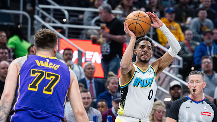 Mar 26, 2025; Indianapolis, Indiana, USA; Indiana Pacers guard Tyrese Haliburton (0) shoots the ball while Los Angeles Lakers guard Luka Doncic (77) defends in the first half at Gainbridge Fieldhouse. Mandatory Credit: Trevor Ruszkowski-Imagn Images Mar 26, 2025; Indianapolis, Indiana, USA; Indiana Pacers guard Tyrese Haliburton (0) shoots the ball while Los Angeles Lakers guard Luka Doncic (77) defends in the first half at Gainbridge Fieldhouse. Mandatory Credit: Trevor Ruszkowski-Imagn Images