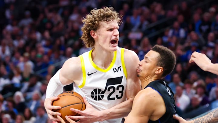 Mar 21, 2024; Dallas, Texas, USA;  Utah Jazz forward Lauri Markkanen (23) drives to the basket as Dallas Mavericks guard Dante Exum (0) defends during the second half at American Airlines Center. Mandatory Credit: Kevin Jairaj-Imagn Images