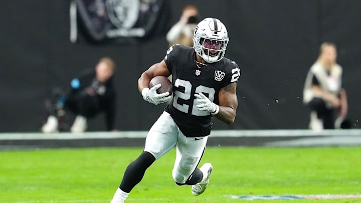 Las Vegas Raiders running back Alexander Mattison (22) gains yardage against the Los Angeles Chargers during the first quarter at Allegiant Stadium. Las Vegas Raiders running back Alexander Mattison (22) gains yardage against the Los Angeles Chargers during the first quarter at Allegiant Stadium.