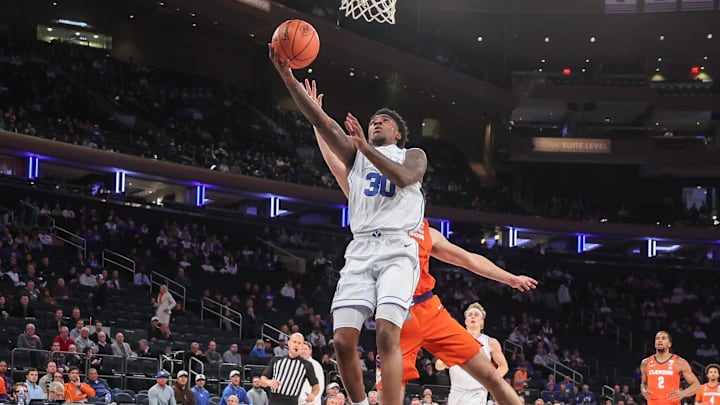 Dec 9, 2025; New York, New York, USA; BYU Cougars guard Kennard Davis Jr. (30) drives past Clemson Tigers forward Nick Davidson (11) in the first half at Madison Square Garden. Mandatory Credit: Wendell Cruz-Imagn Images Dec 9, 2025; New York, New York, USA; BYU Cougars guard Kennard Davis Jr. (30) drives past Clemson Tigers forward Nick Davidson (11) in the first half at Madison Square Garden. Mandatory Credit: Wendell Cruz-Imagn Images
