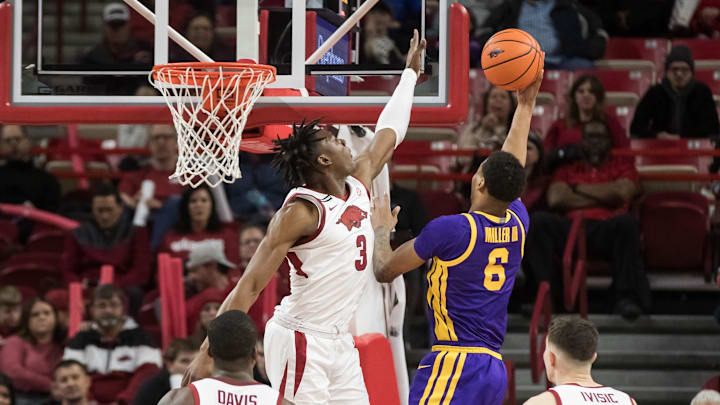 Feb 12, 2025; Fayetteville, Arkansas, USA; LSU Tigers forward Robert Miller III (6) goes up for a shot as Arkansas Razorbacks forward Adou Thiero (3) tries to block it and guard Johnell Davis (1) and forward Zvonimir Ivisic (44) took on during the second half at Bud Walton Arena. Arkansas won 70-58. Mandatory Credit: Brett Rojo-Imagn Images