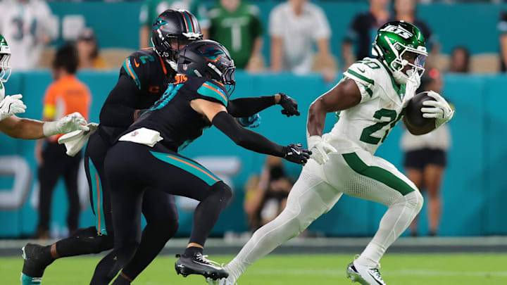 Sep 29, 2025; Miami Gardens, Florida, USA; New York Jets running back Breece Hall (20) rushes the ball against the Miami Dolphins during the first half at Hard Rock Stadium. Mandatory Credit: Sam Navarro-Imagn Images