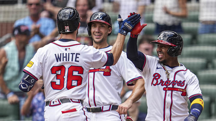 Atlanta Braves outfielder Eli White (36) reacts with first base Matt Olson (28) and second base Ozzie Albies