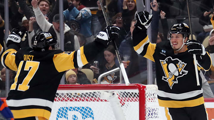 Jan 9, 2025; Pittsburgh, Pennsylvania, USA;  Pittsburgh Penguins right wing Rickard Rakell (right) celebrates his goal with right wing Bryan Rust (17) against the Edmonton Oilers during the first period at PPG Paints Arena. Mandatory Credit: Charles LeClaire-Imagn Images