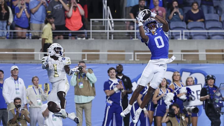 Dec 27, 2025; Orlando, FL, USA; BYU Cougars defensive back Evan Johnson (0) intercepts the ball in the end zone from Georgia Tech Yellow Jackets running back Jamal Haynes (1) to end the Pop-Tarts Bowl at Camping World Stadium. Mandatory Credit: Nathan Ray Seebeck-Imagn Images