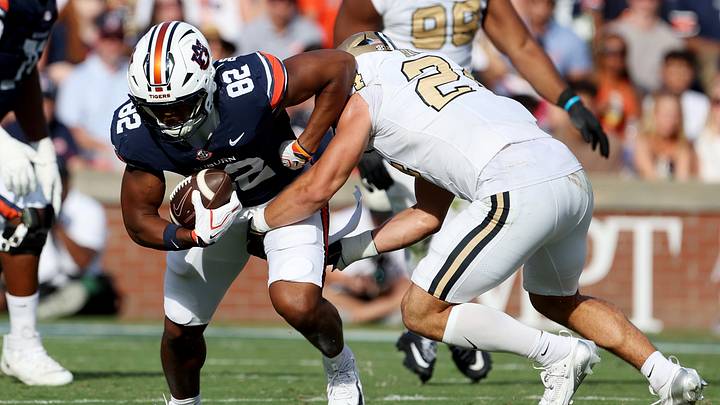 Sep 26, 2026; Auburn, Alabama, USA;  Auburn Tigers tight end Arlis Boardingham (82) is tackled by Vanderbilt Commodores defensive lineman Nick Rinaldi (24) during the second half Jordan-Hare Stadium.  Mandatory Credit: John Reed-Imagn Images