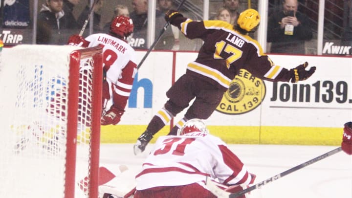 Wisconsin goaltender Kyle McClellan watches Minnesota's Brody Lamb celebrate after scoring the game-winning goal in a 2-1 overtime victory Friday February 2, 2024 at the Kohl Center in Madison, Wisconsin.
