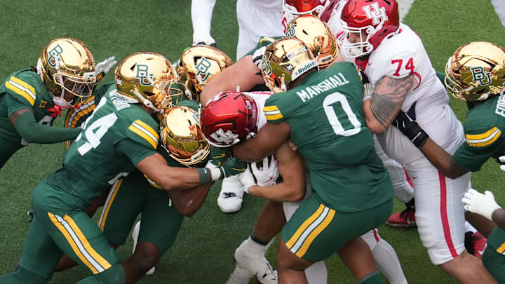 Nov 29, 2025; Waco, Texas, USA; Houston Cougars running back Dean Connors (44) is stopped for a short gain by Baylor Bears defensive lineman Jackie Marshall (0) during the first half at McLane Stadium. Mandatory Credit: Chris Jones-Imagn Images