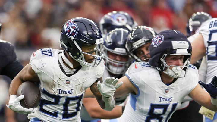 Nov 24, 2024; Houston, Texas, USA;Tennessee Titans running back Tony Pollard (20) rushes against the Houston Texans  in the fourth quarter at NRG Stadium. Mandatory Credit: Thomas Shea-Imagn Images