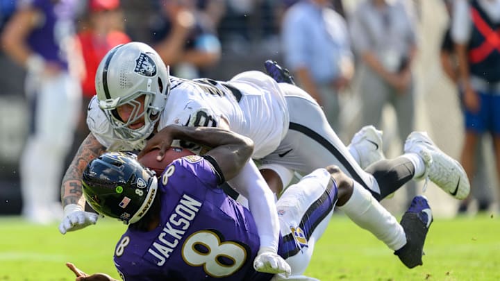 Sep 15, 2024; Baltimore, Maryland, USA; Las Vegas Raiders defensive end Maxx Crosby (98) sacks Baltimore Ravens quarterback Lamar Jackson (8) during the second half at M&T Bank Stadium. Mandatory Credit: Reggie Hildred-Imagn Images